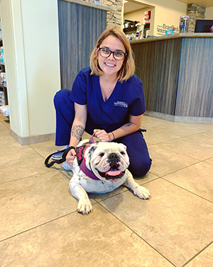 Vet Tech holding a dog.