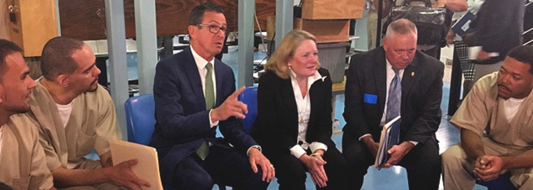 Governor Malloy and Commissioner Semple speaking with women at York Correctional Institution