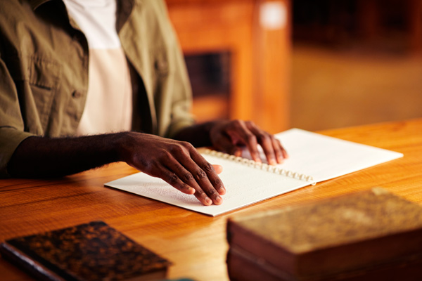 Hands reading Braille