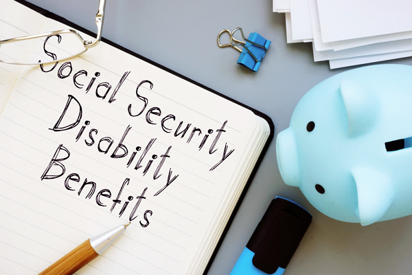 The text social security disability benefits is handwritten in a notebook