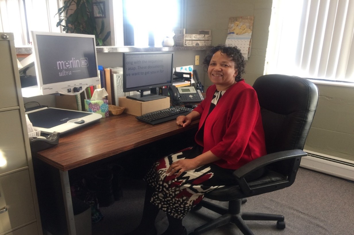 photo of smiling woman at desk