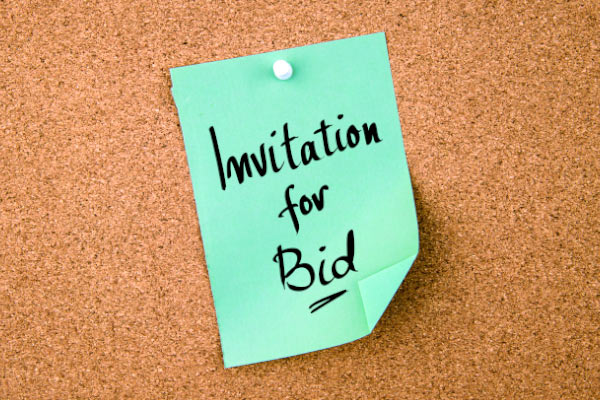 Corkboard with Invitation to Bid note posted.