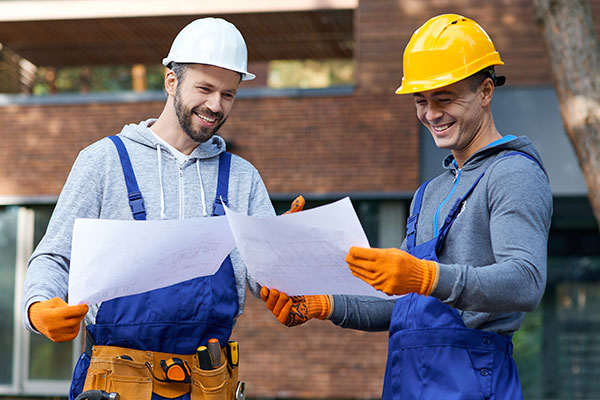 construction workers with blueprints