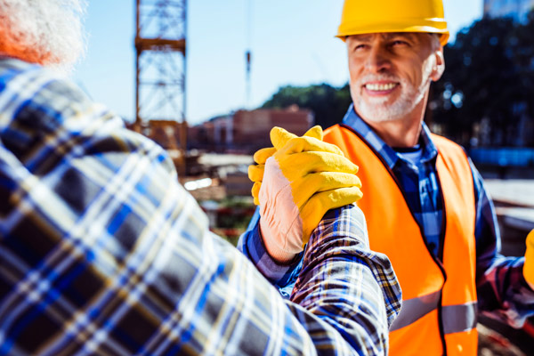 Construction workers shaking hands.
