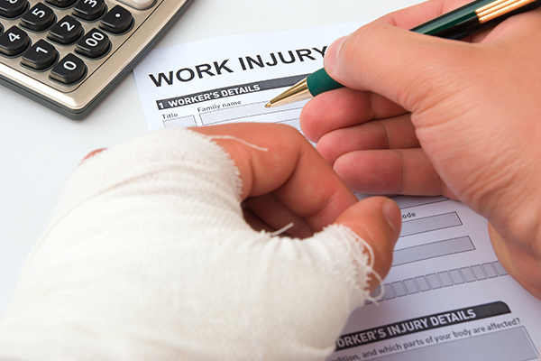  Injured worker filling out work injury claim form