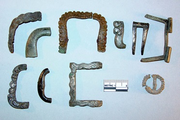 Various copper alloy shoe-buckle frame fragments and a small pewter clothing buckle Various copper alloy shoe-buckle frame fragments and a small pewter clothing buckle