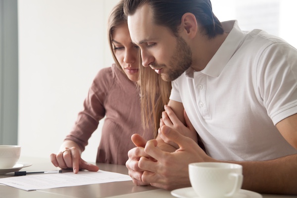 husband and wife reading document