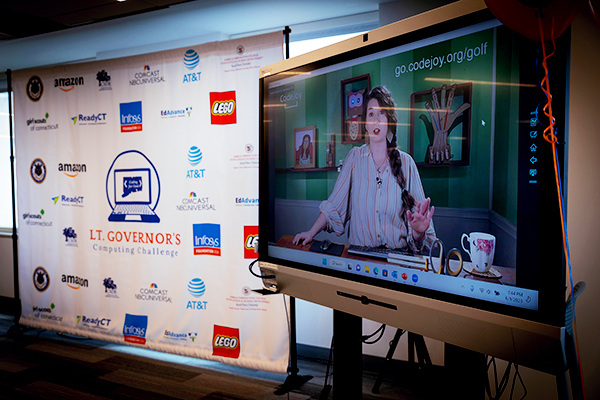 An educator on a large screen providing remote learning.