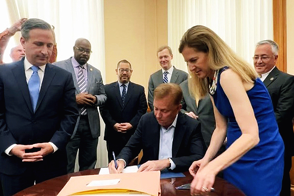 Governor Lamont signing a Bill into Law with Lt. Governor Bysiewicz