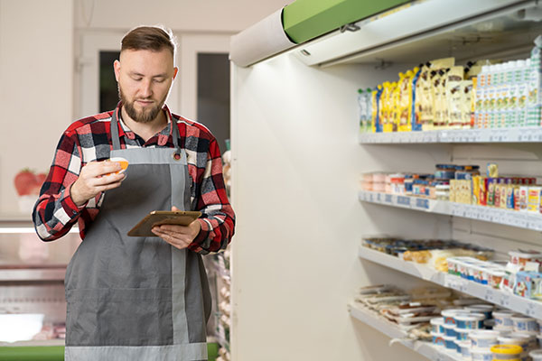 grocery store manager doing inventory