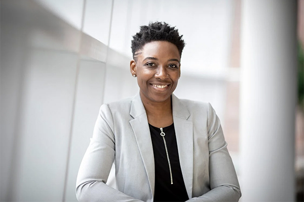 A young professional smiling before going into an interview.