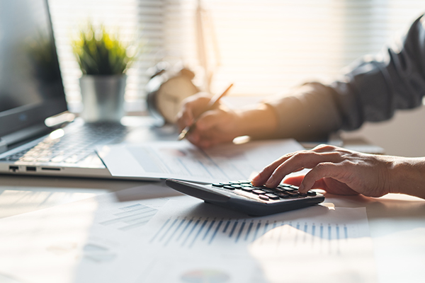 Businessman calculating business balance