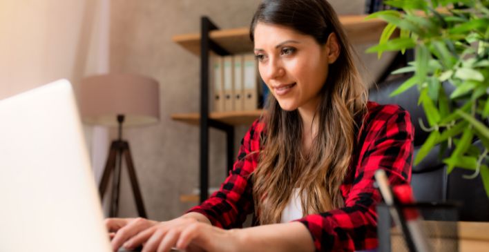 Woman typing on a laptop